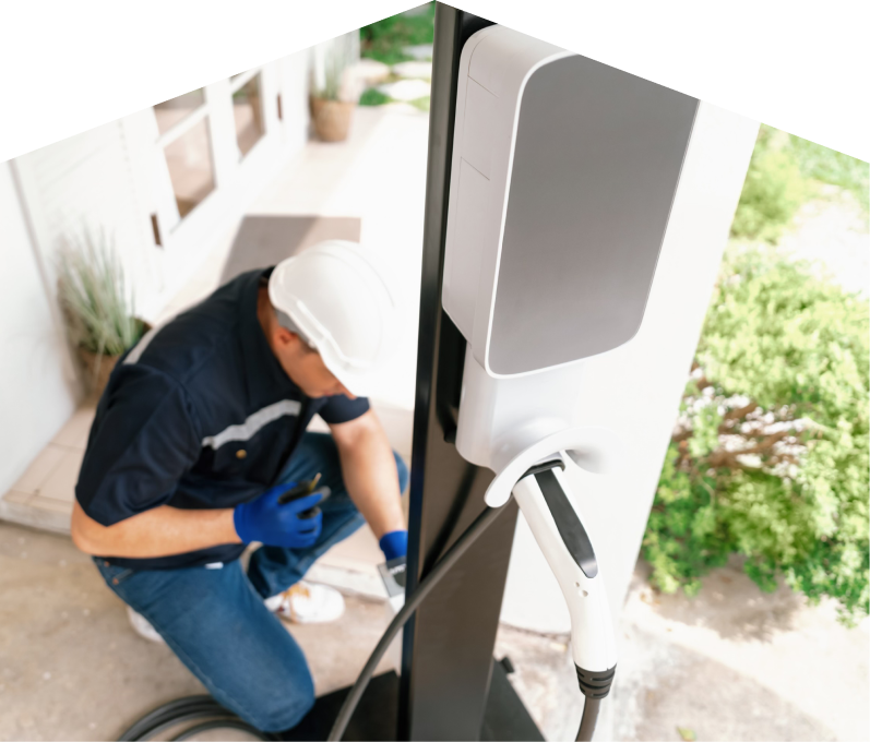 Home service electrician from 669 Heat installing an EV charger fixed to a vertical post near a residential entryway. Home service electrician from 669 Heat installing an EV charger fixed to a vertical post near a residential entryway.