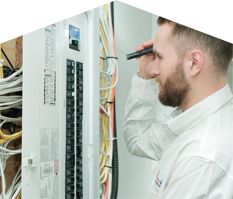 669 Heat electrician inspecting residential electrical panel wiring with a flashlight, checking connections and circuit labels. 669 Heat electrician inspecting residential electrical panel wiring with a flashlight, checking connections and circuit labels.