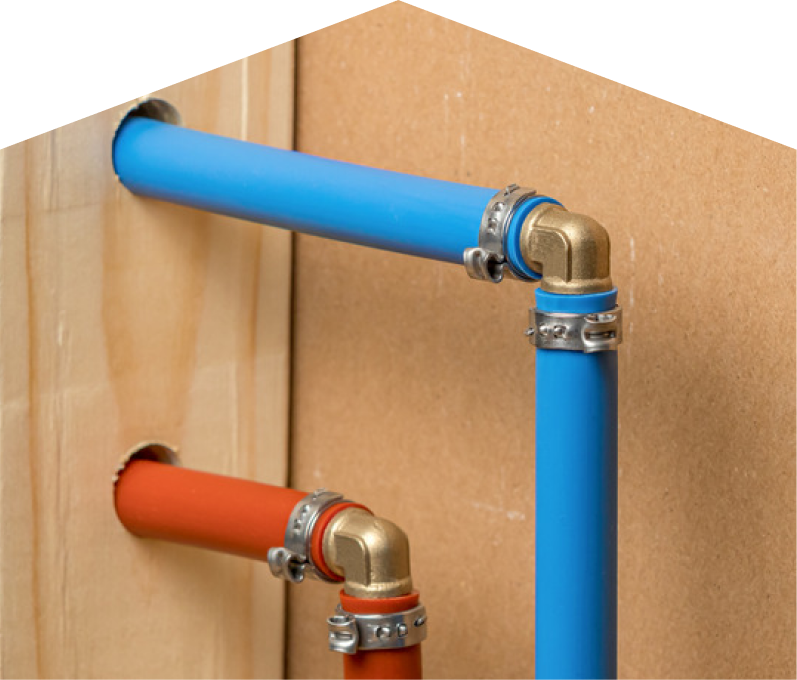 669 Heat kitec plumbing system with blue and orange plastic pipes connected by brass fittings and metal clamps, mounted on a wooden panel. 669 Heat kitec plumbing system with blue and orange plastic pipes connected by brass fittings and metal clamps, mounted on a wooden panel.
