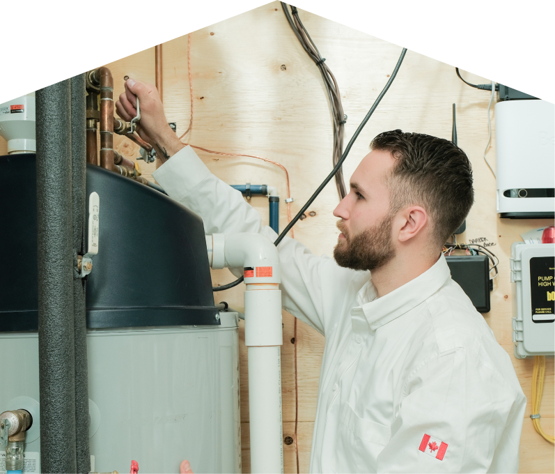 669 Heat water heater specialist adjusts piping on a large residential unit during a repair service, with exposed wood paneling and mounted utility components in the background. 669 Heat water heater specialist adjusts piping on a large residential unit during a repair service, with exposed wood paneling and mounted utility components in the background.