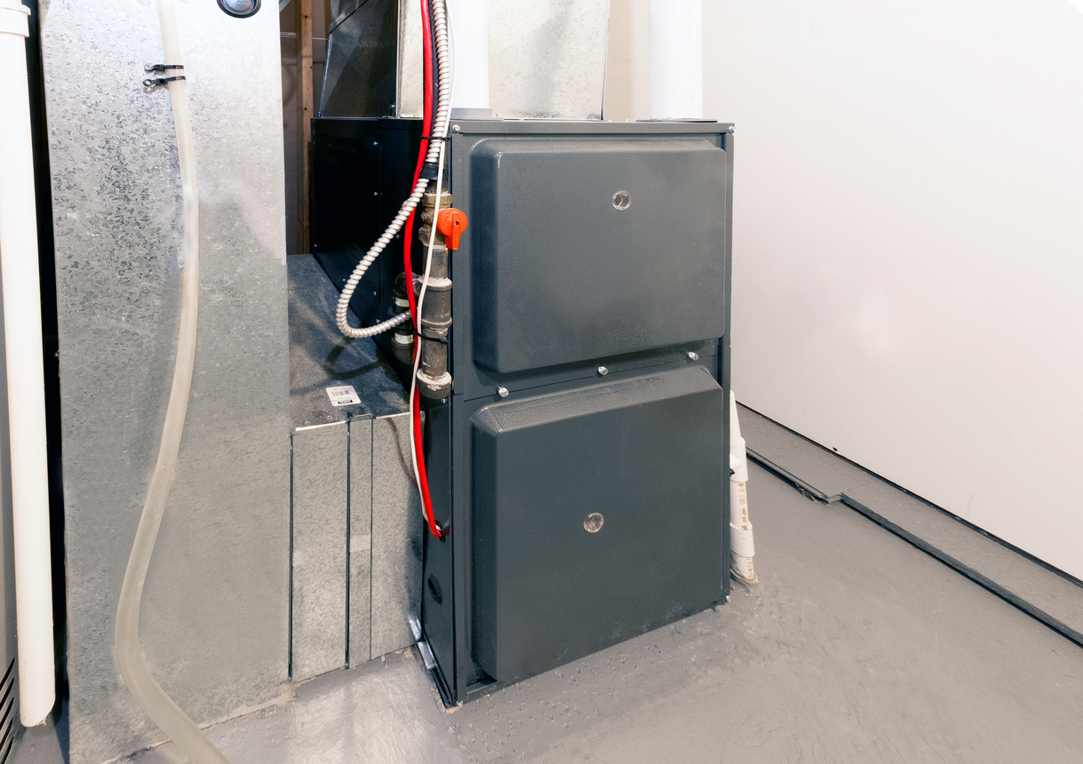 A home high energy efficient furnace in a basement A home high energy efficient furnace in a basement
