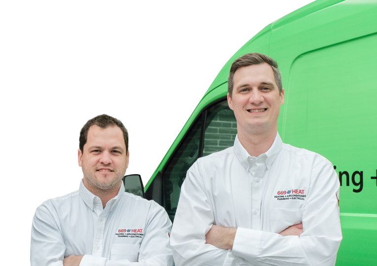 Two 669 Heat technicians smiling in front of their green service van, wearing issued jackets during an on-site consultation.